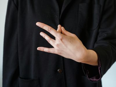 Close-up of hands in a meditative mudra pose.